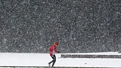 Ein Mann rennt bei winterlichem Wetter am Mittwoch, dem elften Januar 2017, in Berlin durch starken Schneefall.