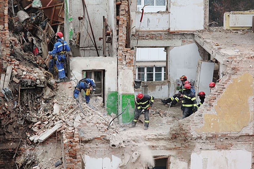 Rescue workers clear the rubble of a residential building which was heavily damaged by a Russian strike on Ternopil, 21 November, 2025