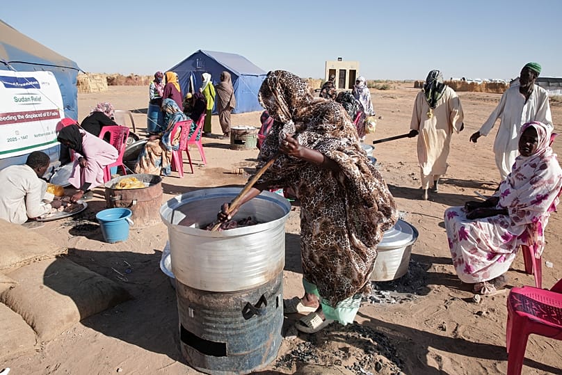 Sudanese women displaced from El-Fasher cook at a community kitchen inside the El-Afadh camp in Al Dabbah, 16 November, 2025