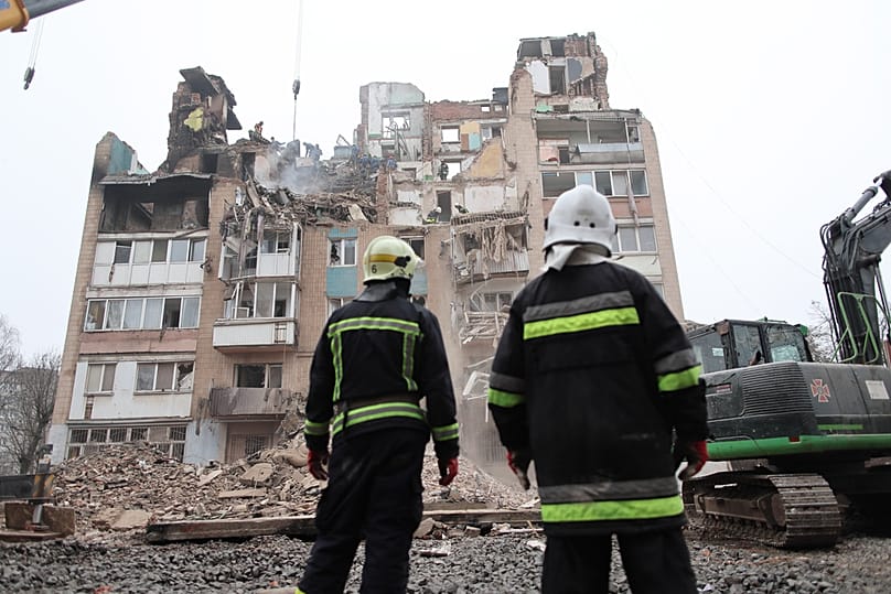 Rescue workers clear the rubble of a residential building which was heavily damaged by a Russian strike on Ternopil, Ukraine, Friday, Nov. 21, 2025. 