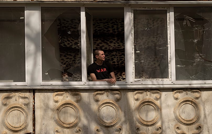 FILE: A man smokes as he looks out from his damaged home following a Russian bombing earlier this month, in Mykolaiv, Ukraine, 31 March 2022