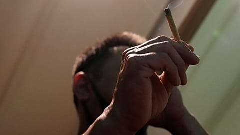 A tourist smokes cannabis at a shop in Bangkok, Thailand, on June 27, 2023.