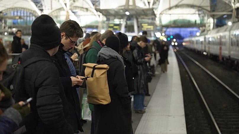 Commuters wait on train platform as three-day strike commences, impacting public transport on its first day. Leuven, Belgium. 24 November, 2025.