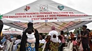 Women wait to administer the malaria vaccine to their children in Abidjan, Ivory Coast.