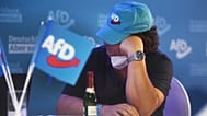 FILE - A member of the AfD sits at the AfD election party in Berlin, September 2021. Exit polls show the center-left Social Democrats in a very close race with the ruling CDU.