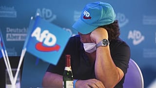 FILE - A member of the AfD sits at the AfD election party in Berlin, September 2021. Exit polls show the center-left Social Democrats in a very close race with the ruling CDU.