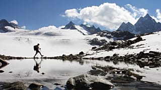 A hiker walks near the Silvretta glacier in the Swiss Alps near the town of Klosters, Switzerland in this Sept. 16, 2007 file photo.