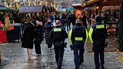 Polizisten sichern einen Weihnachtsmarkt in Berlin.