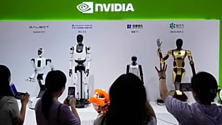 FILE - Visitors give commands to robots at Nvidia's booth during the China International Supply Chain Expo at the China International Exhibition Center in November.