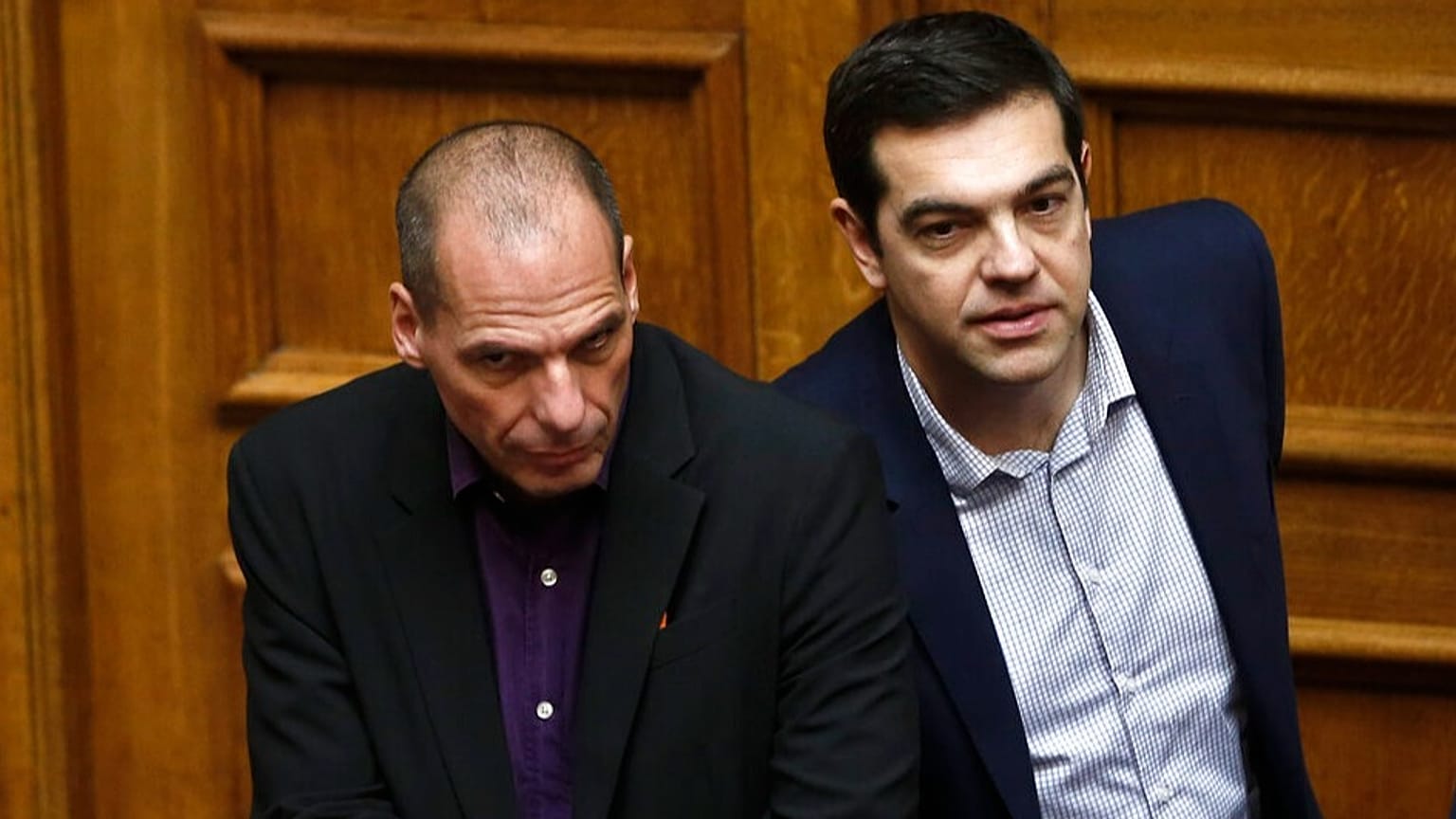 FILE: Greek Minister Alexis Tsipras, right and his Finance Minister Yanis Varoufakis look on during the vote for the president of Greece's parliament in Athens, Feb. 6, 2015.