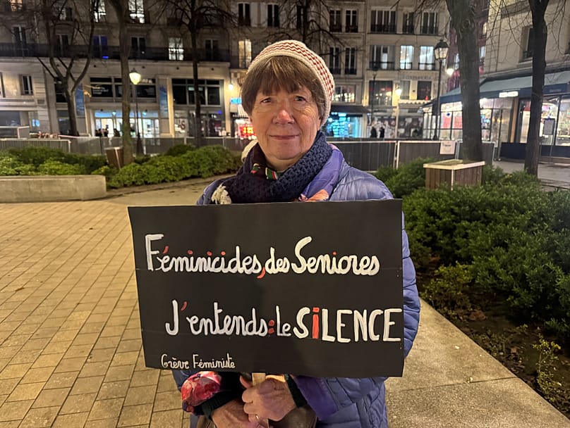 Maire-Josée holds a poster denouncing the gender-based violence that imapcts senior women