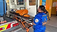 An emergency rescue team transports an elderly woman in Nonthaburi province, Thailand, Nov. 23, 2025.