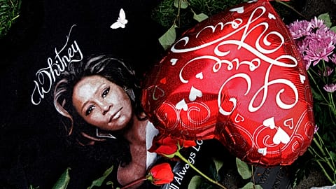 Items are displayed near a likeness of Whitney Houston at a memorial for the late star in California on Feb. 13, 2012.