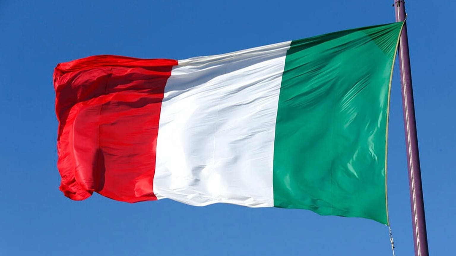 FILE: An Italian flag waves during a bilateral meeting between Italy and Russia, in Trieste, Italy, Tuesday, Nov. 26, 2013