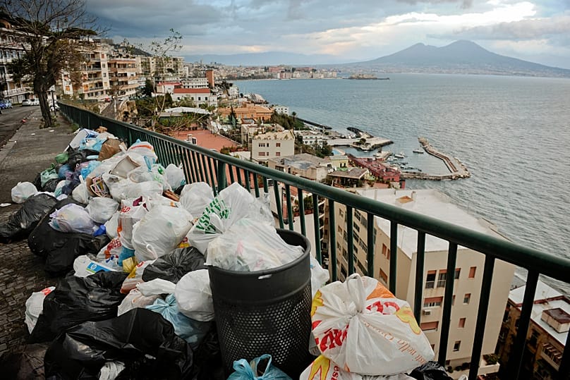 Uncollected trash is piled up on a sidewalk in Naples, Italy, on Nov. 22, 2010. 