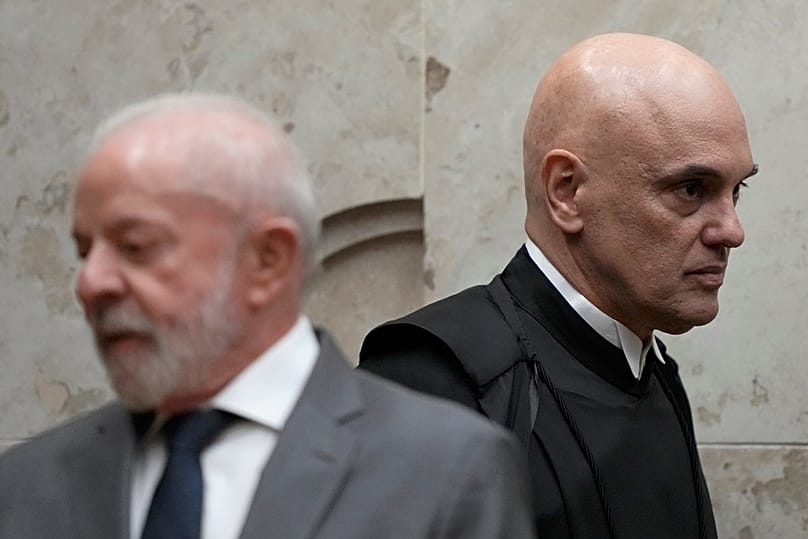 Judge Alexandre de Moraes walks past Brazil's President Luiz Inacio Lula da Silva during the swearing-in ceremony, in Brasilia, Brazil, Monday, Sept. 29, 2025