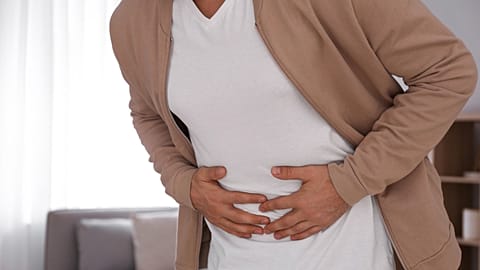 A person clutches their stomach.