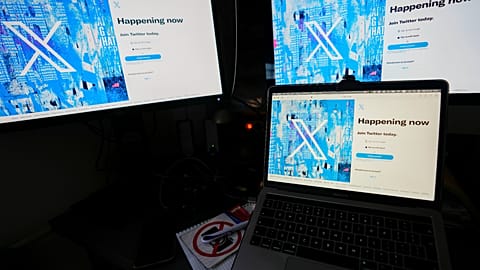 Computer monitors and a laptop display the X, formerly known as Twitter, sign-in page, July 24, 2023, in Belgrade, Serbia. 