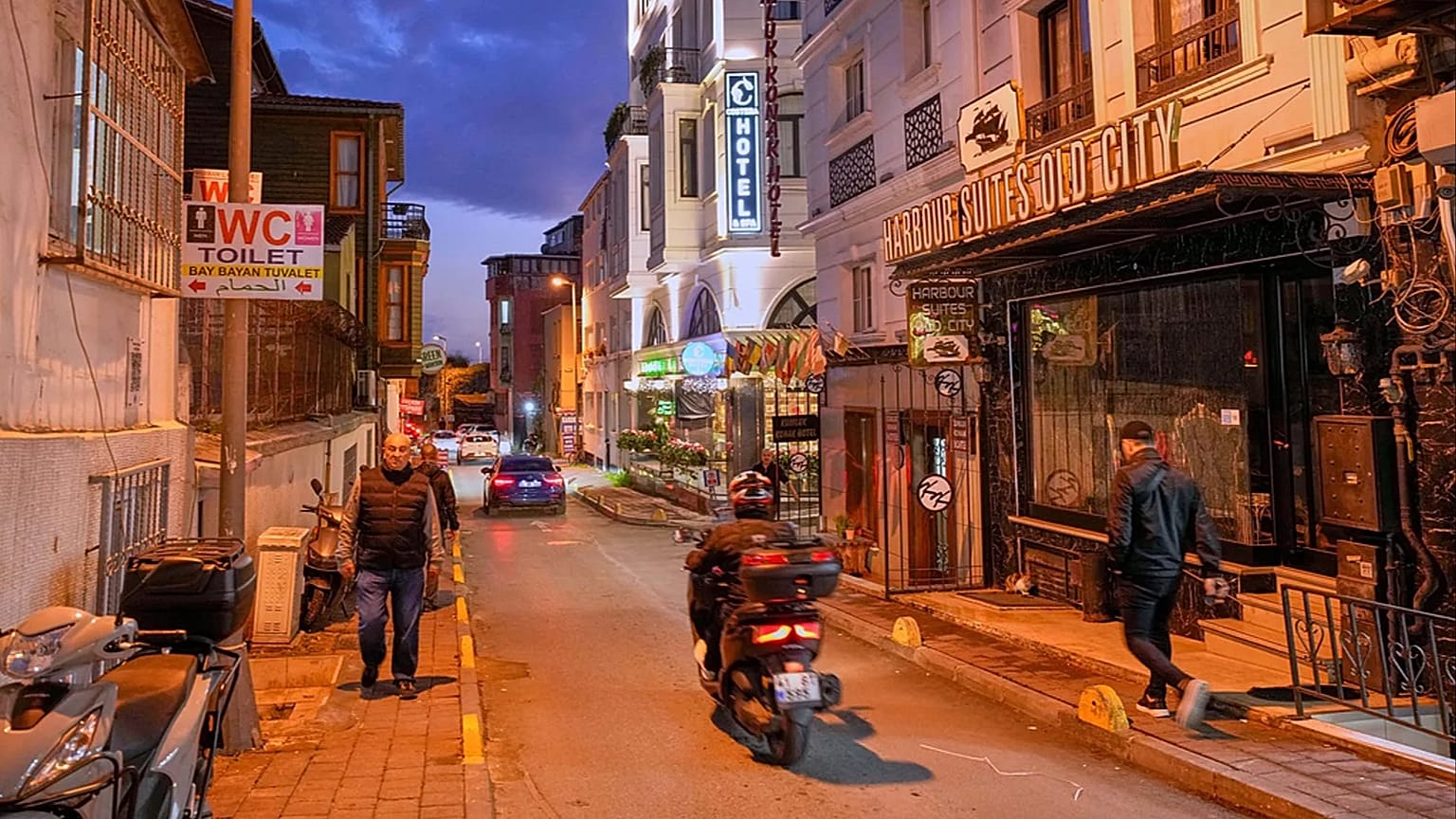People walk past the Harbour Suites Old City hotel, in Istanbul, 24 November 2025
