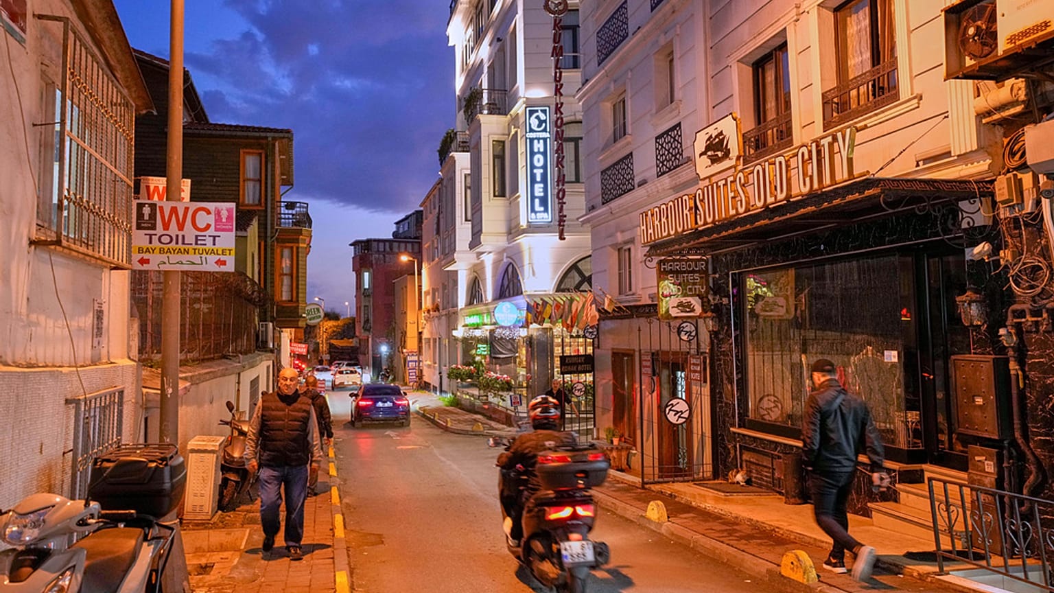 People walk past the Harbour Suites Old City hotel, in Istanbul, 24 November 2025