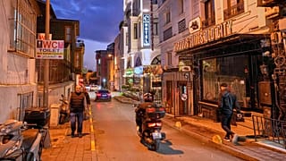 People walk past the Harbour Suites Old City hotel, in Istanbul, 24 November 2025
