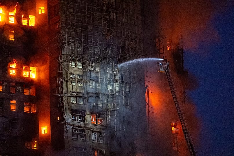 Firefighters work to extinguish a fire which broke out at Wang Fuk Court, a residential estate in the Tai Po district of Hong Kong's New Territories, 26 November 2025