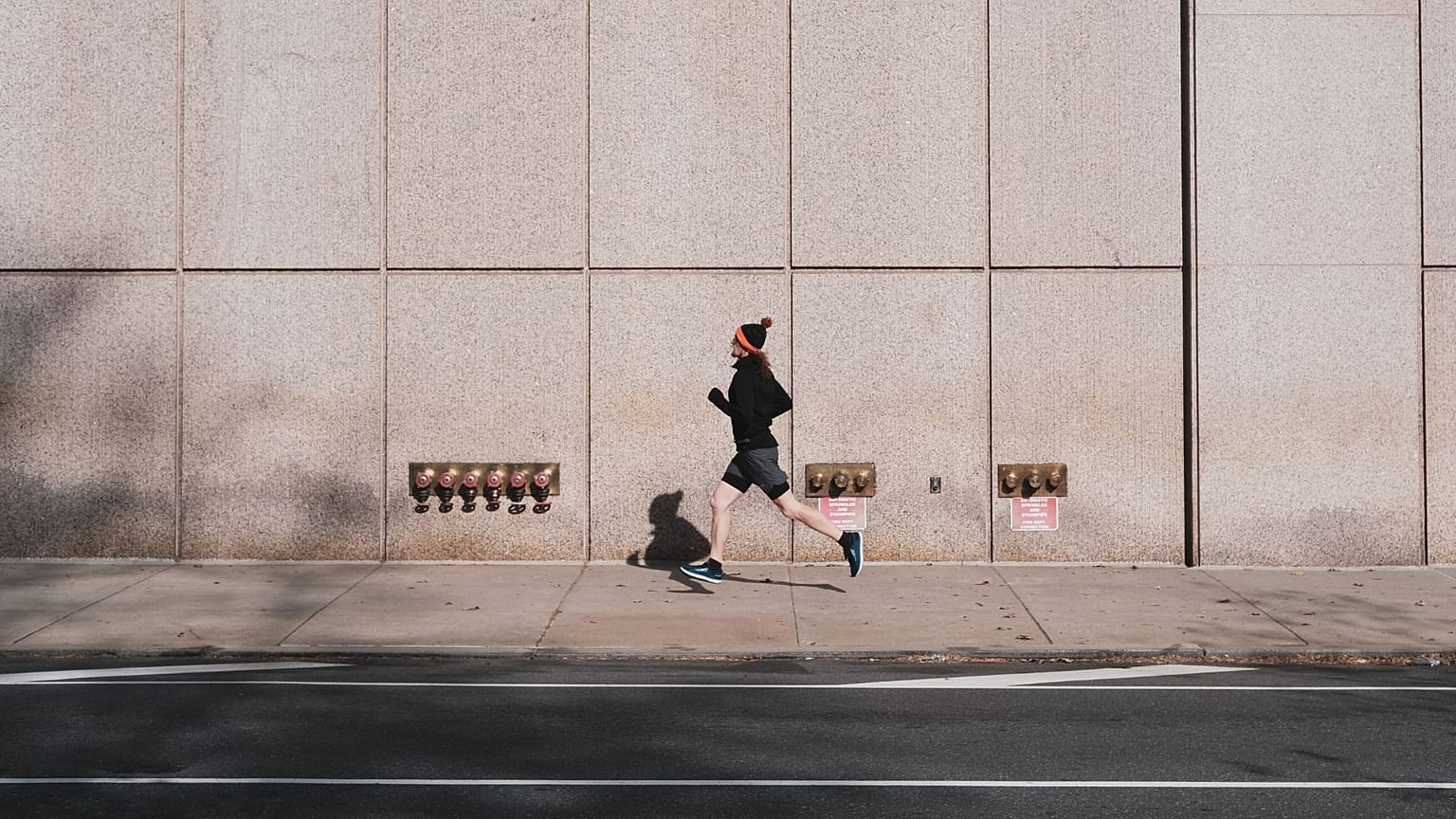 A jogger runs in a city.