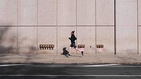 A jogger runs in a city.