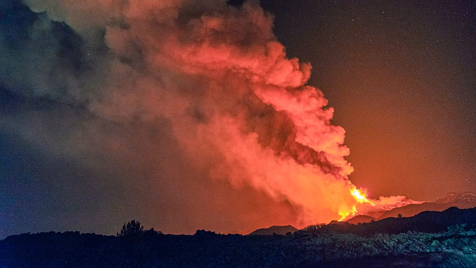 Lava gushes from the Mt Etna volcano near Catania, Sicily, early Thursday, Feb. 18, 2021.
