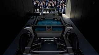 FILE. Attendees look at the next generation battery swapping station from China-based CATL, the world's largest EV battery maker in Xiamen, China. 18 Dec. 2024