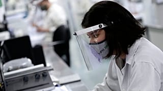 An employee works at a laboratory in Brazil in 2021.