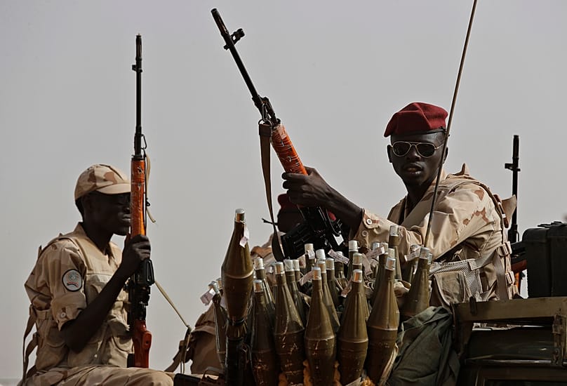 Sudanese soldiers from the Rapid Support Forces unit secure the area where Gen Mohammed Hamdan Dagalo attends a rally, in the East Nile province, 22 June 2019