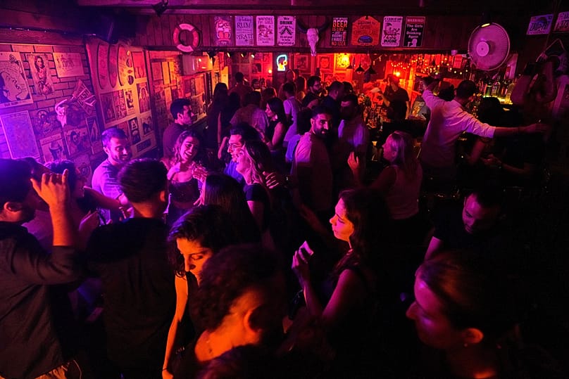 FILE: People dance at a bar as they enjoy the first night of the weekend in Damascus, 3 October 2025