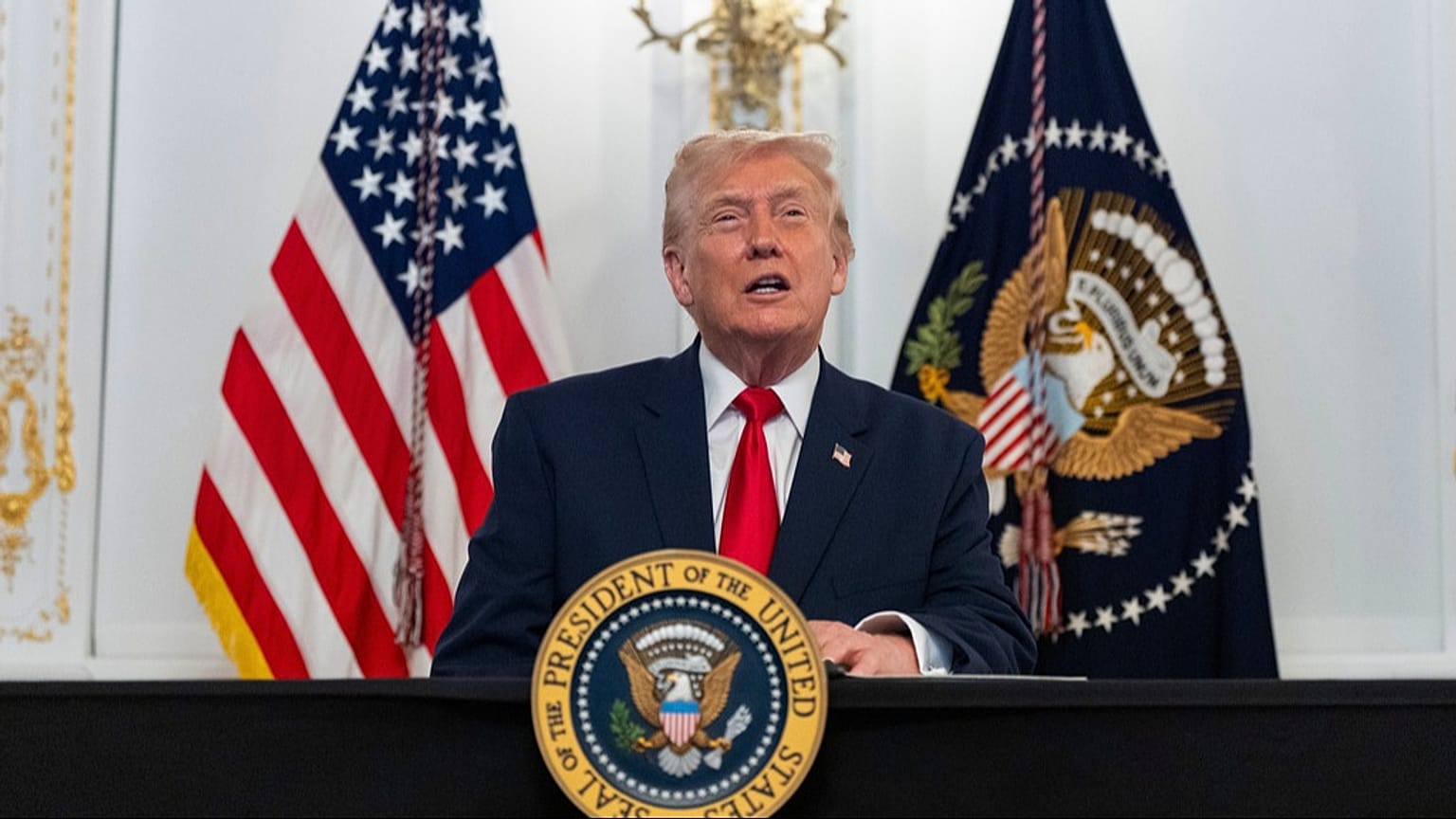 US President Donald Trump speaks to troops via video from his Mar-a-Lago estate on Thanksgiving, Thursday, Nov. 27, 2025, in Palm Beach, Florida