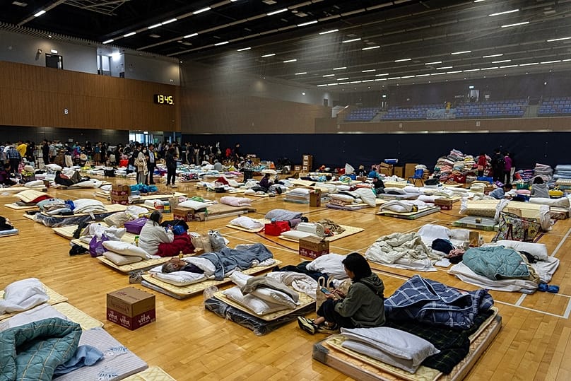 Residents rest at a temporary shelter near the fire scene at Wang Fuk Court, a residential estate in the Tai Po district of Hong Kong New Territories, Thursday, Nov. 27, 2025