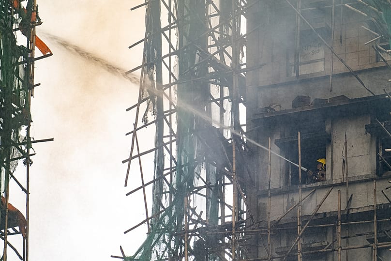 A firefighter works to extinguish a fire that broke out at Wang Fuk Court, a residential estate in the Tai Po district of Hong Kong's New Territories, Thursday, Nov. 27 2025