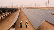 Engineers walk next to solar panels at Benban Solar Park in Aswan, Egypt, Oct. 19, 2022
