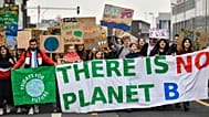 Young protestors march with a banner reading 'There is no planet B' during a climate strike of school students as part of the Fridays for Future movement.