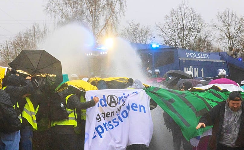 Police use water cannons against demonstrators blocking the B429 near the Lahnbrücke bridge, in Hesse, Germany, Saturday, Nov. 29, 2025. 