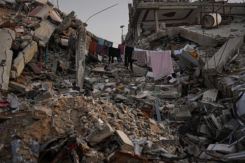 Laundry hangs between the rubble left by Israeli air and ground offensive in Gaza City, Saturday, Nov. 29, 2025.