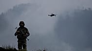 A drone hovers near an Indian soldier