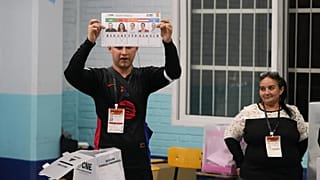 Un funcionario electoral muestra una papeleta marcada para el candidato presidencial Rixi Moncada, del gobernante Partido Libertad y Refundación (LIBRE), durante el recuento de votos.