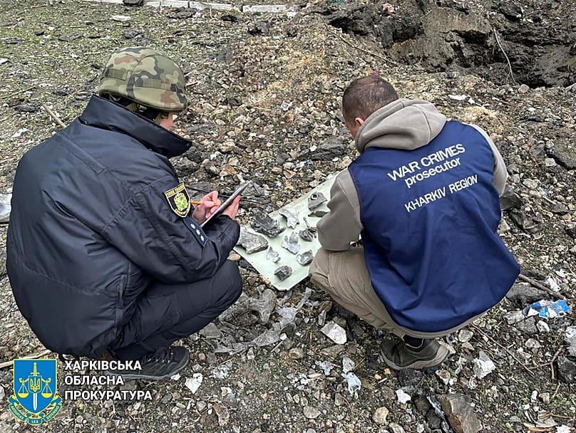 FILE: war crime prosecutors inspect fragments of bomb after Russia's attack in Kharkiv, Ukraine, Wednesday, April 24, 2024.