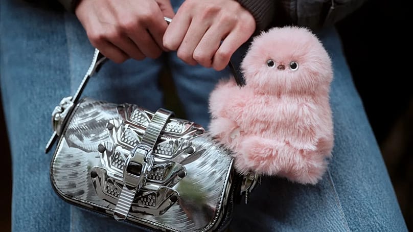 A Mirumi clinging to a handbag