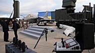 A Rafale jet fighter, drones and ammunitions are seen before the arrival of Ukrainian President Volodymyr Zelenskyy at the Villacoublay air base near Paris, 17 November 2025