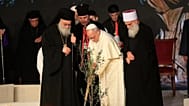 Pope Leo XIV plants an olive tree, flanked by Greek Orthodox Patriarch of Antioch John X Yazig
