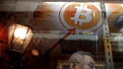 FILE -  In this 8 December 2017 photograph, a man uses a Bitcoin ATM in Hong Kong.