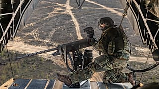 A soldier observes the surroundings at the M3M machine gun on the rear ramp of the CH-53 during the Griffin Lightning 2025 exercise in Lithuania, 10 May, 2025