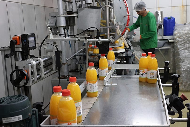 A worker bottles orange juice at the Morro Alto farm in Limeira, 16 July, 2025