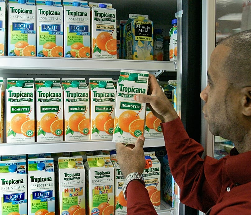 An employee of Target removes a container of orange juice from a display case at the Tallahassee store, 13 October, 2006